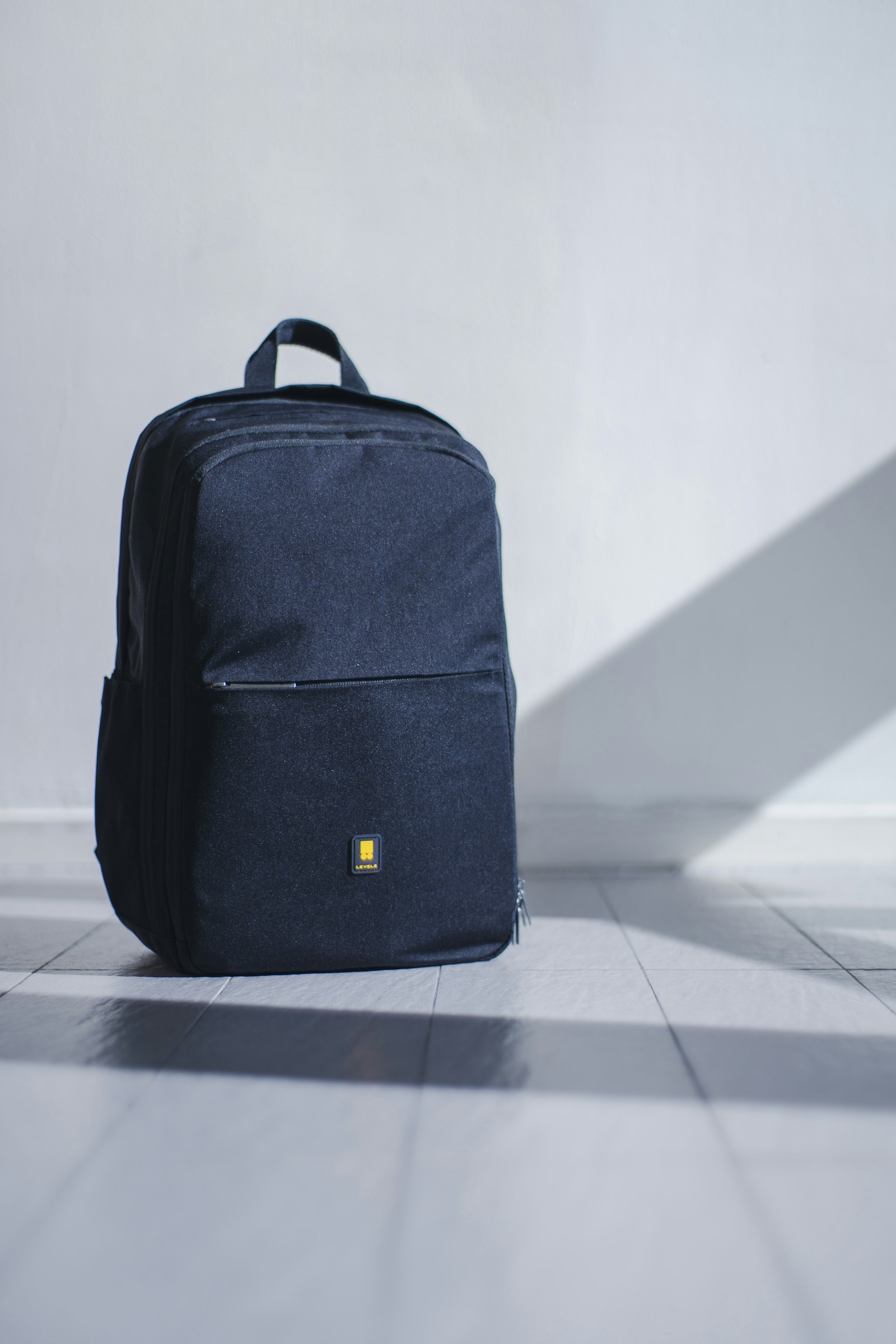 A neat, half-open suitcase on a hotel bed, with folded garment bags and a structured beauty case.
